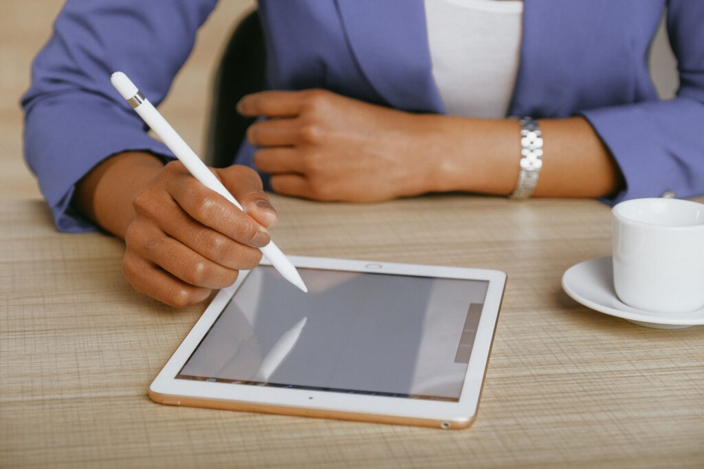 A person using an ipad on a table