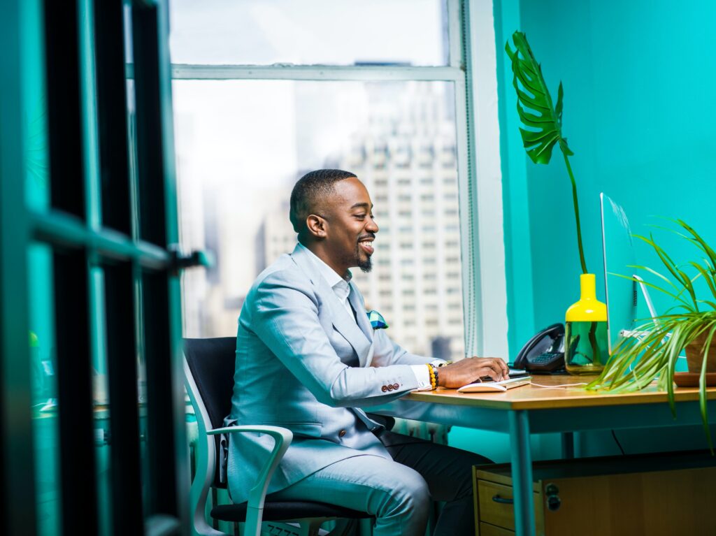 A man sitting at a table with a laptop.