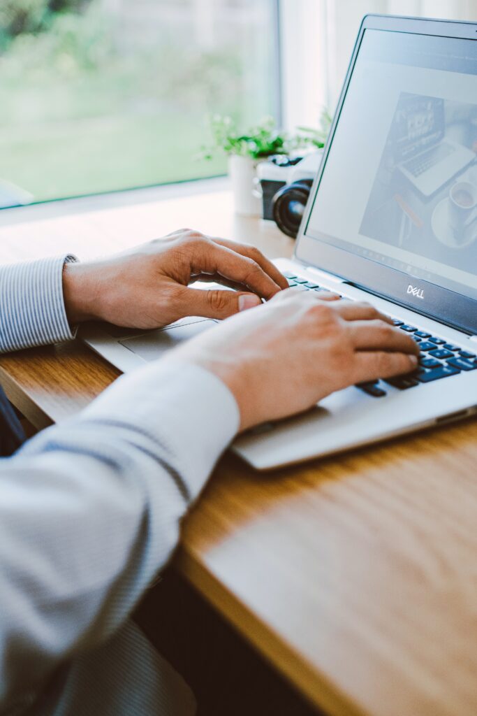 A person typing on a laptop computer.